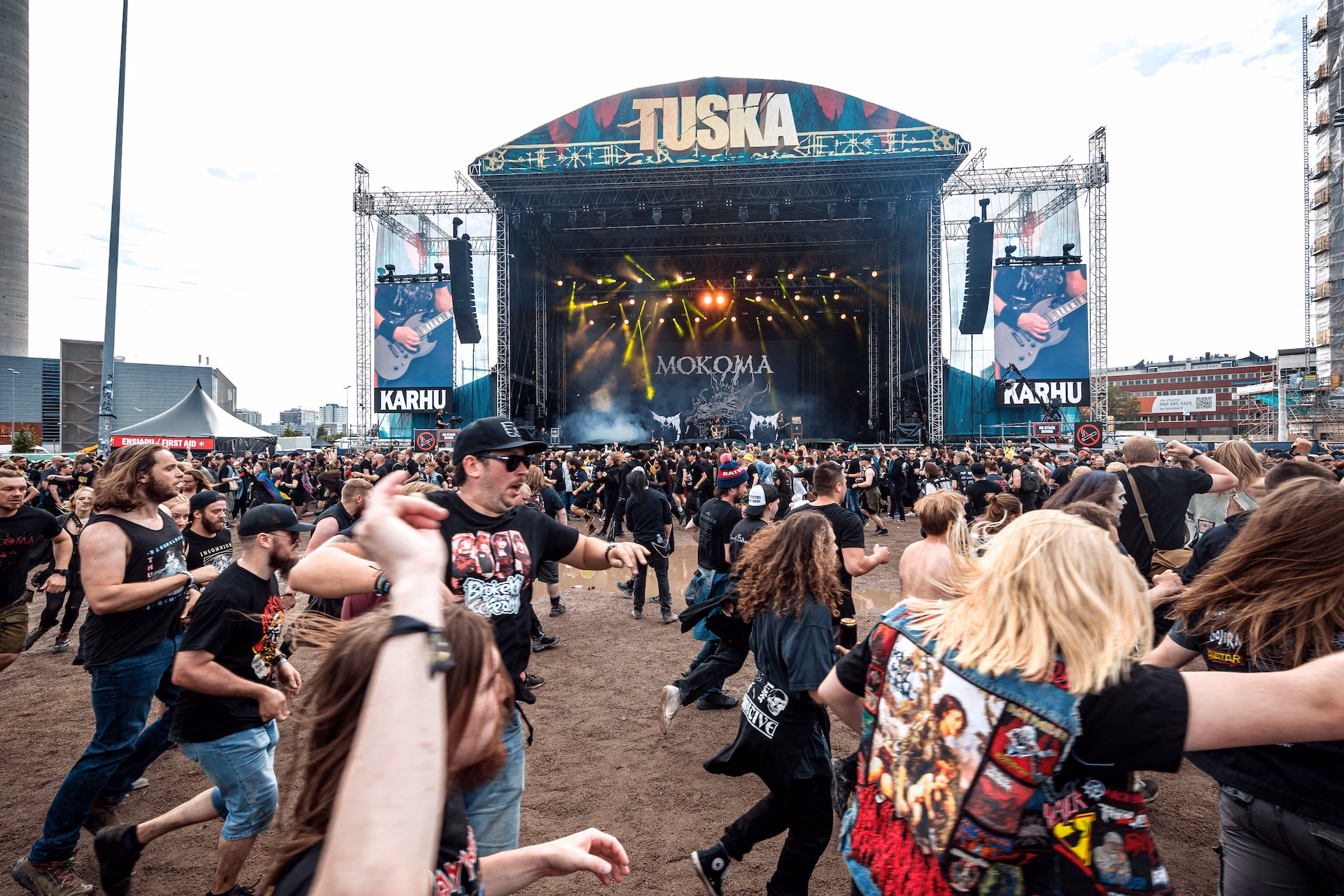 Lauma ihmisiä juoksee ympyrää musiikkilavan edustalla.